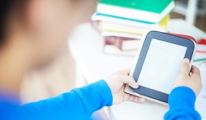 Hands of students holding and using touchpad