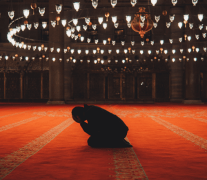 man praying in masjid