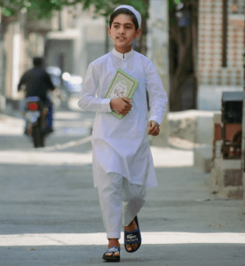 muslim kid happily going to read quranic surahs